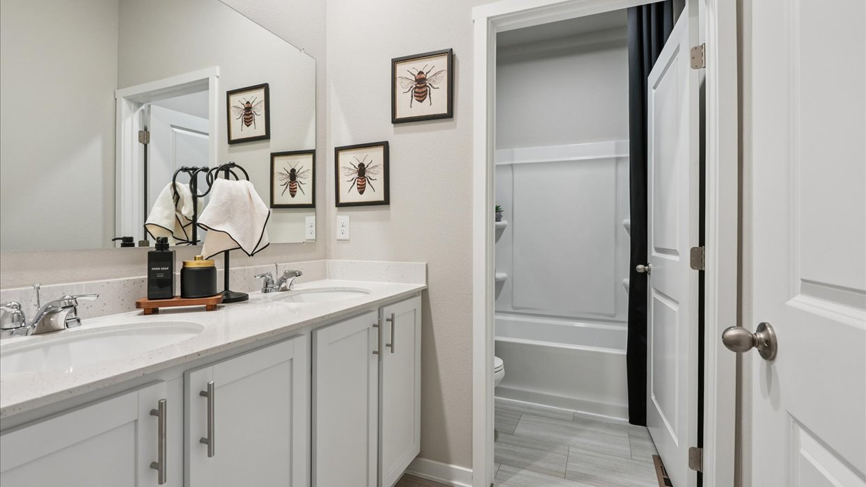 Stylish full bathroom with bright lighting and functional design.