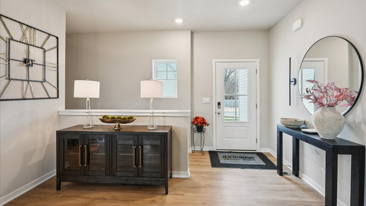 Bright front hallway featuring a welcoming entry space and room for a small table or accents.
