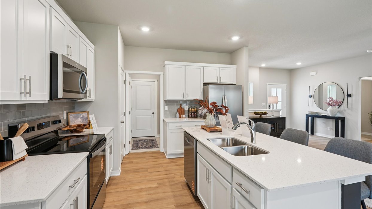 Kitchen with white cabinetry and quartz countertop