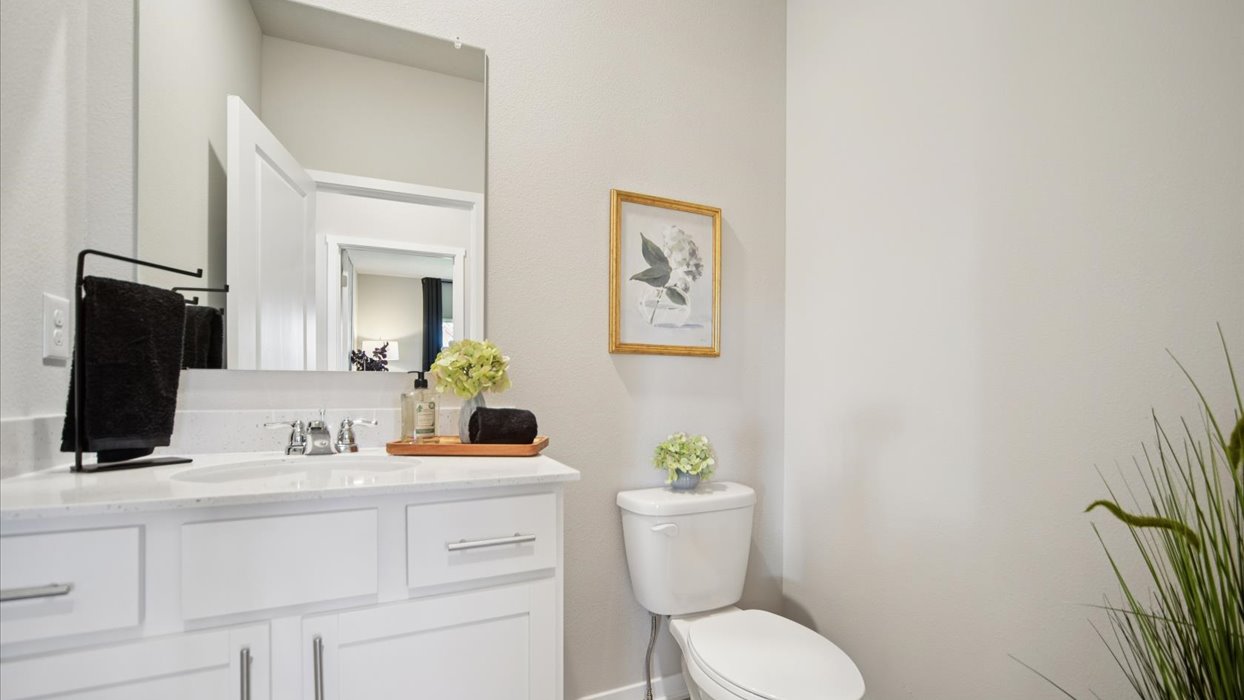 Convenient main-level powder room with updated fixtures and bright lighting.
