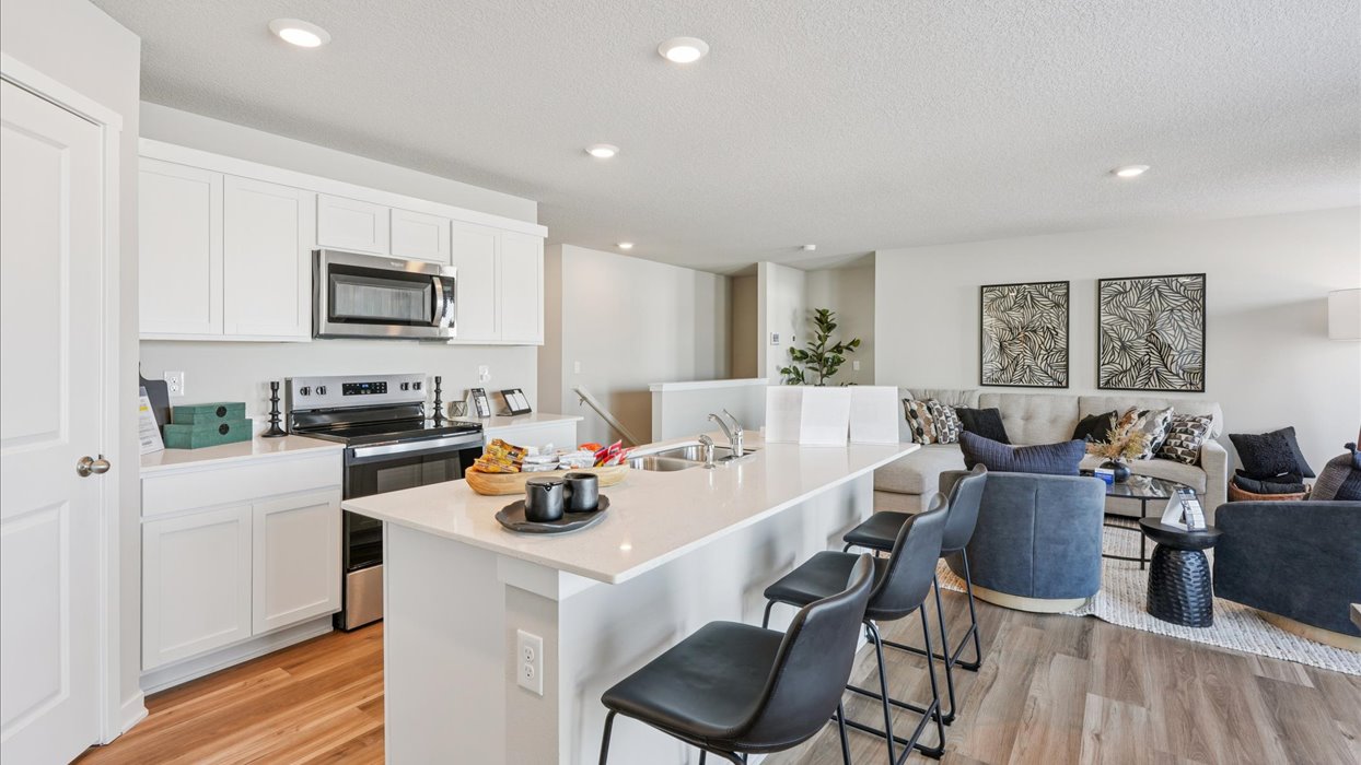 white kitchen with quartz countertops and island