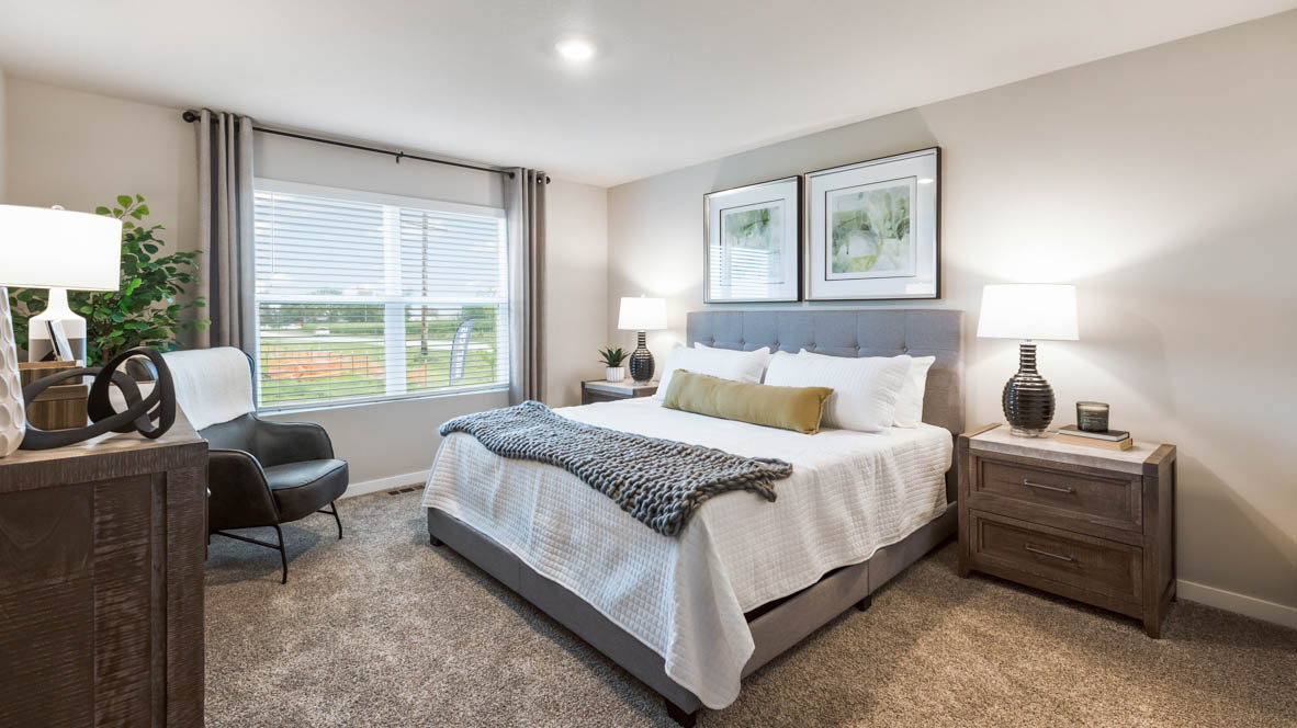 Spacious primary suite with natural light, attached bathroom, & walk in closet