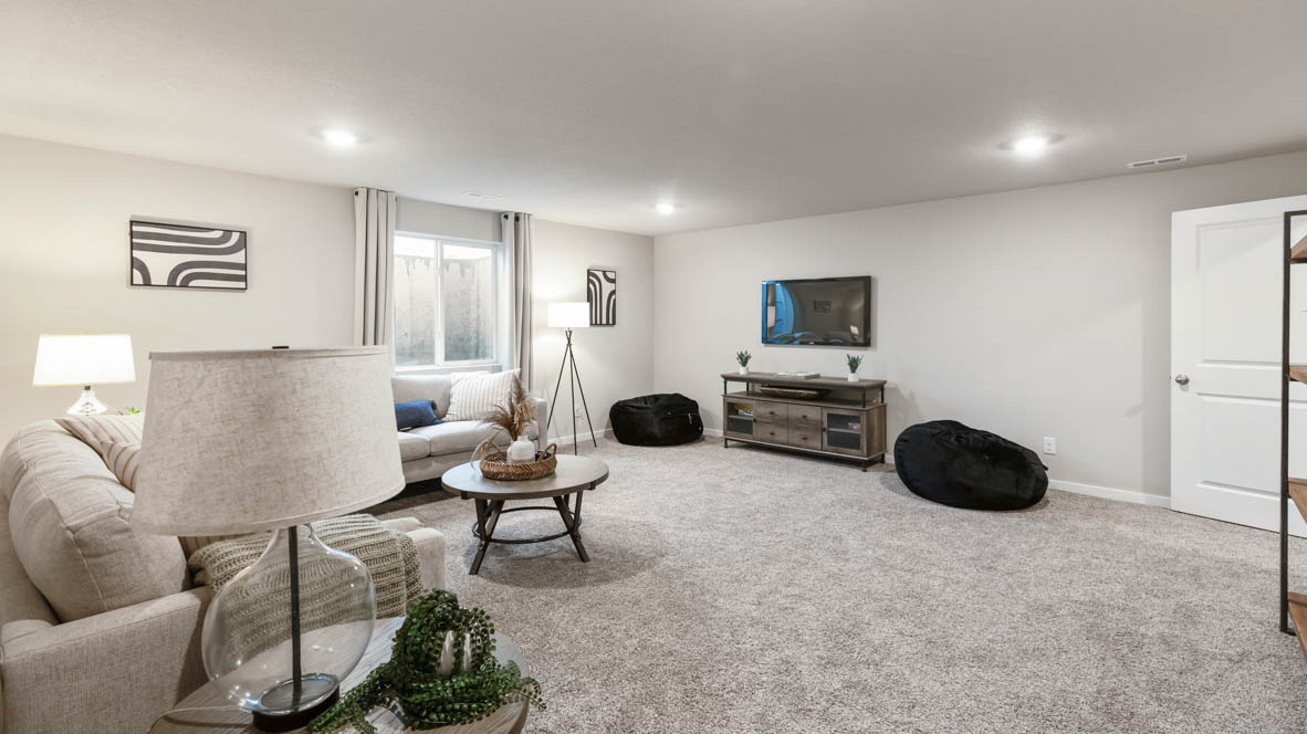 Finished basement living area with comfortable seating space and flexible room for entertaining or relaxing.