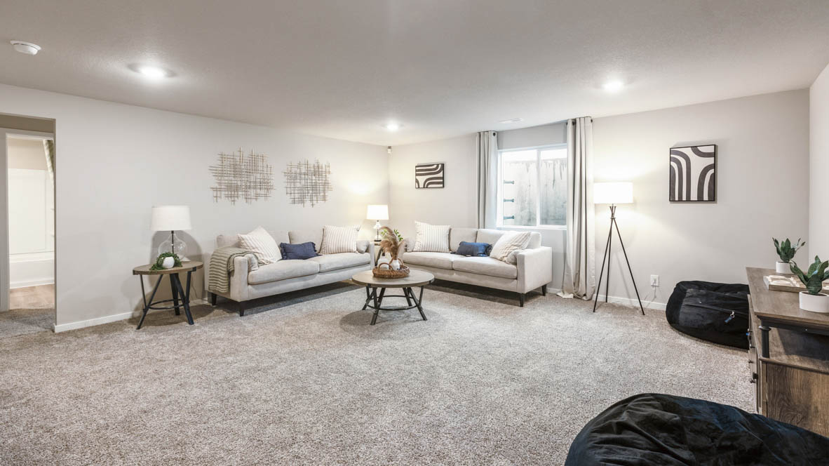 Finished basement living area with comfortable seating space and flexible room for entertaining or relaxing.