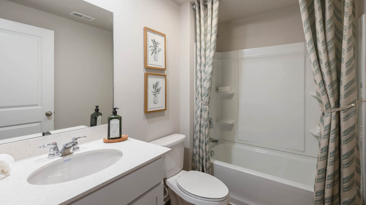 Bathroom with tub and shower combo, quartz countertops, and white vanity