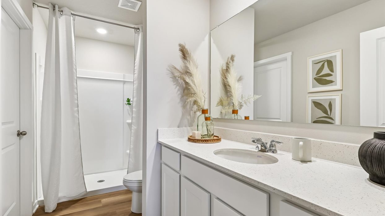 Stylish full bathroom with bright lighting and functional design.