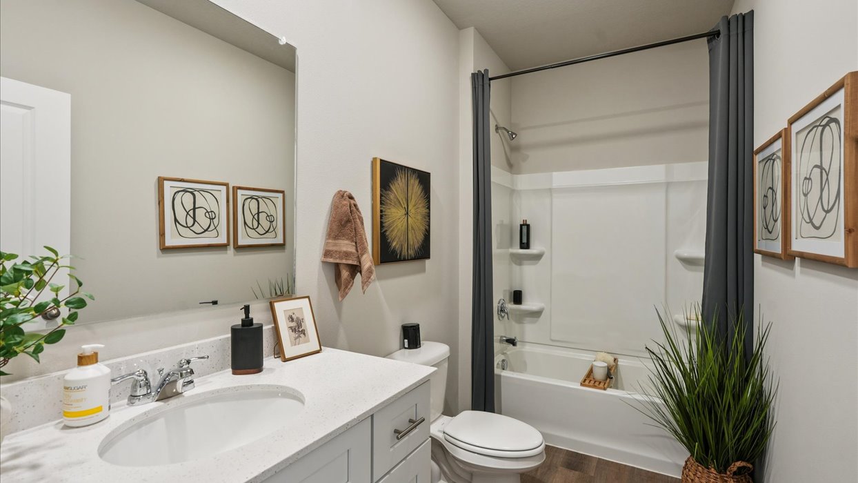 Stylish full bathroom with bright lighting and functional design.