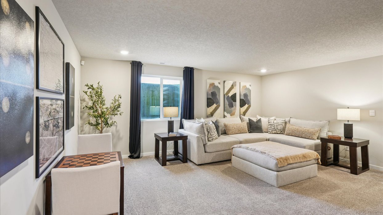 Finished basement living area with comfortable seating space and flexible room for entertaining or relaxing.