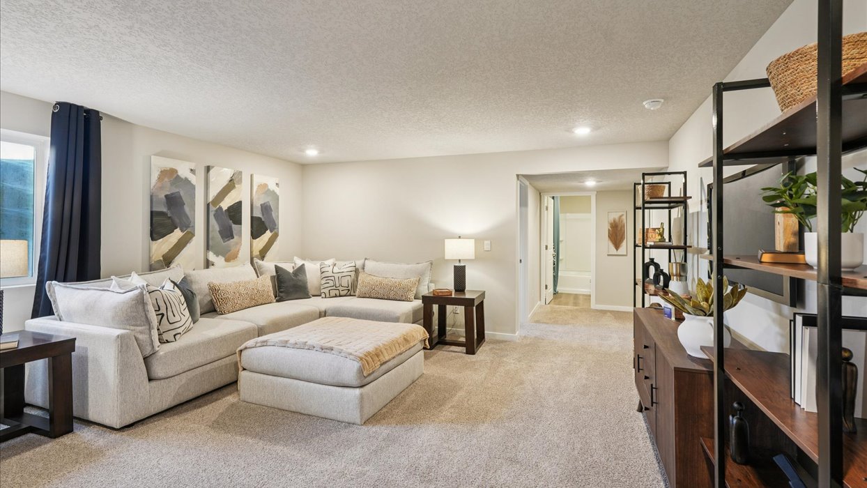 Finished basement living area with comfortable seating space and flexible room for entertaining or relaxing.