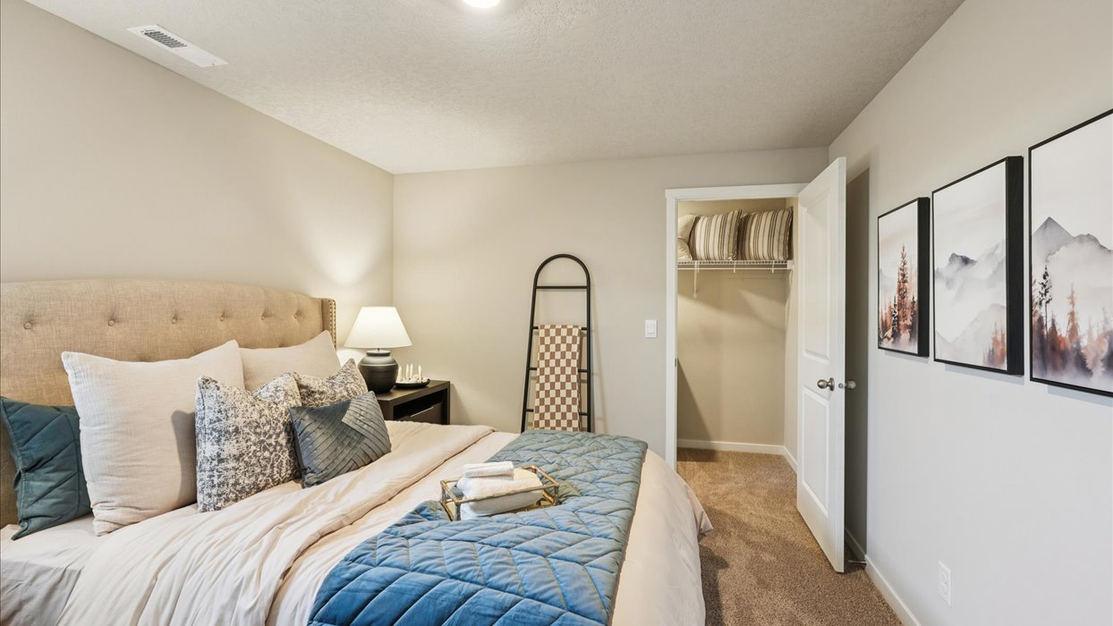 Private lower-level bedroom with natural light and functional storage space.