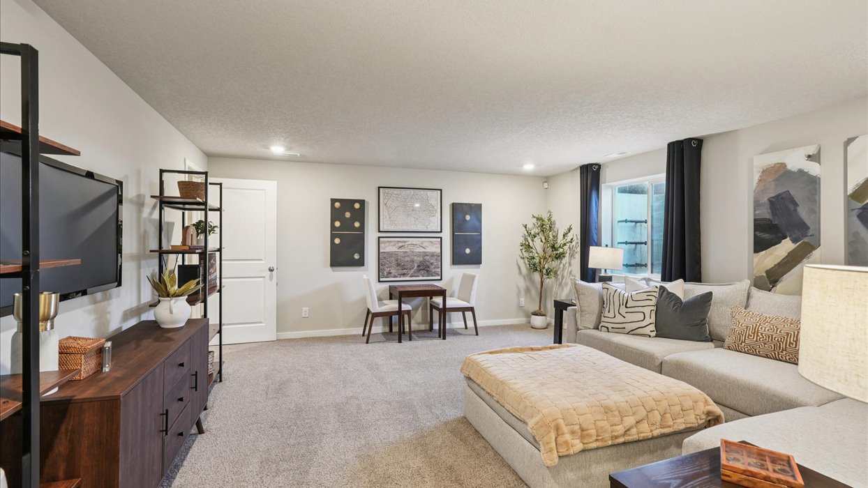 Finished basement living area with comfortable seating space and flexible room for entertaining or relaxing.