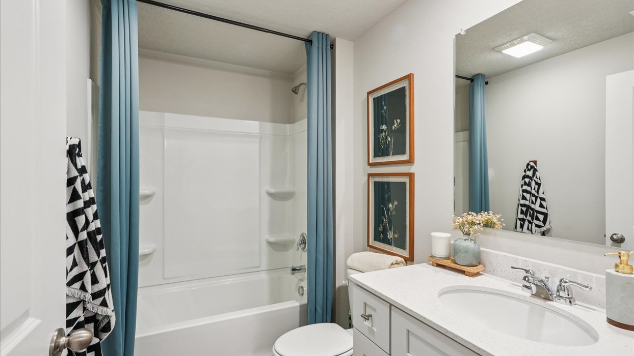 Stylish lower-level bathroom featuring contemporary fixtures and convenient access from the finished basement.