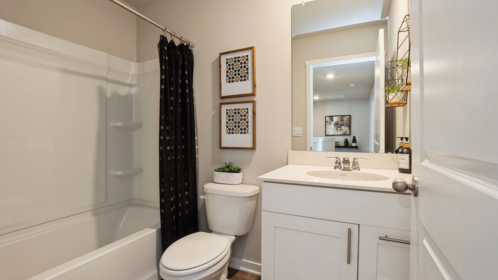 Bathroom with tub and shower combo, quartz countertops, and white vanity