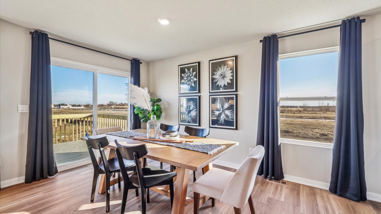 dining area with wood table next to sliding glass doors