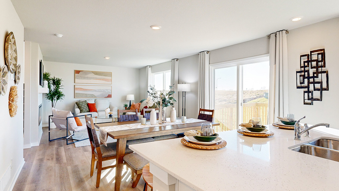 Kitchen with stainless steel appliances, quartz countertops, and white cabinetry