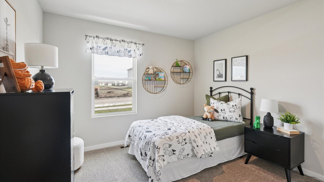 Comfortable secondary bedroom with natural light, modern finishes, and versatile living space.