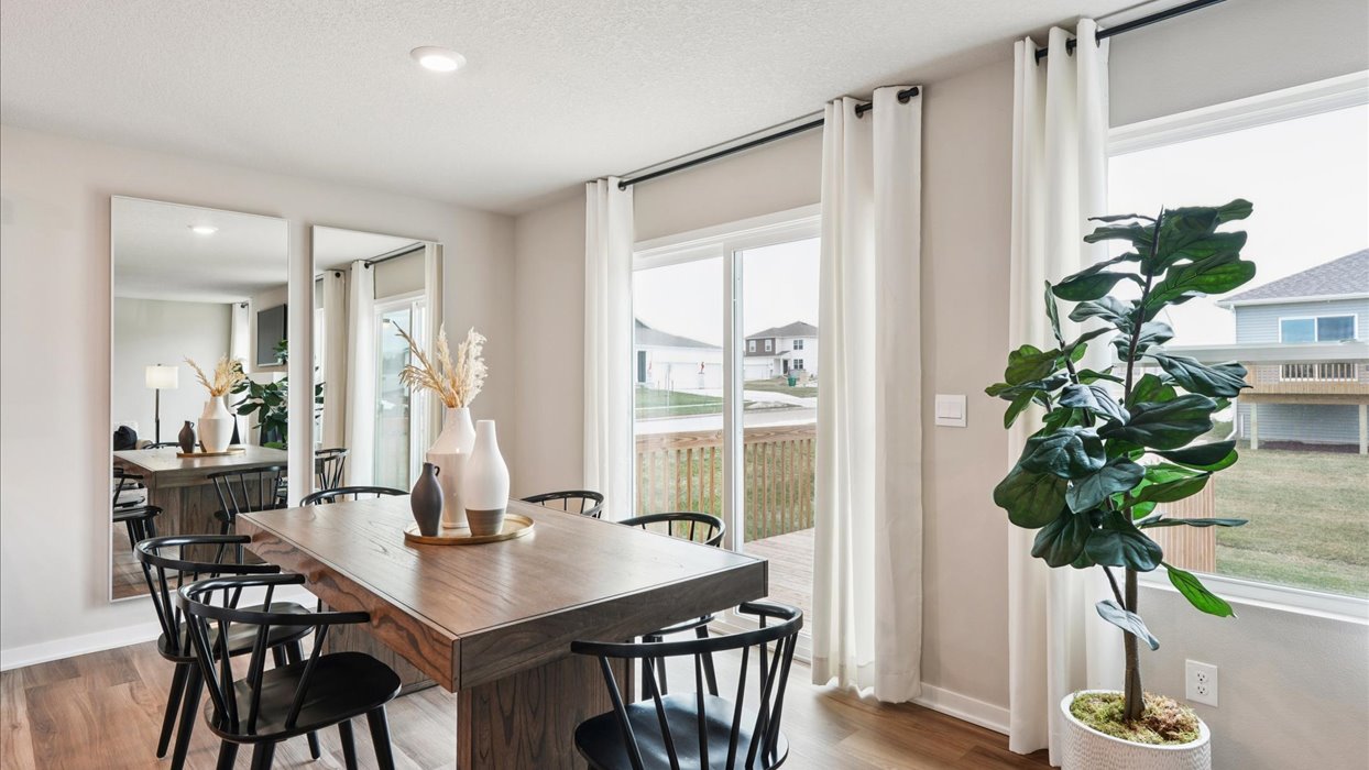 Open concept dining space with access to backyard
