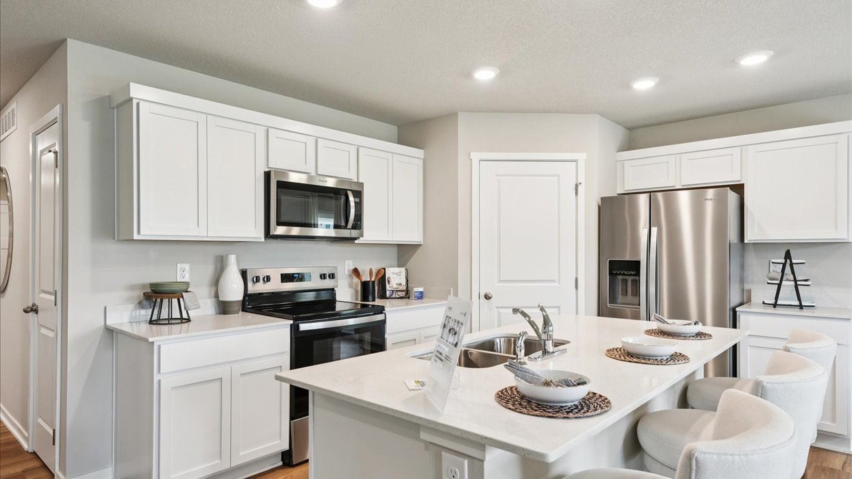 Kitchen with white cabinetry and quartz countertop