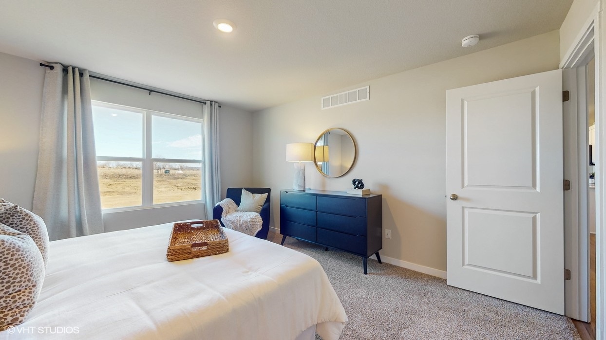 Primary bedroom with natural lighting and spacious layout
