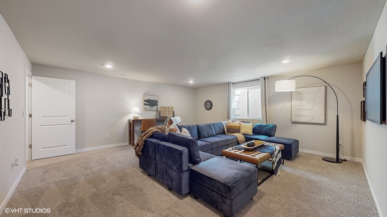 Finished basement living area with comfortable seating space and flexible room for entertaining or relaxing.