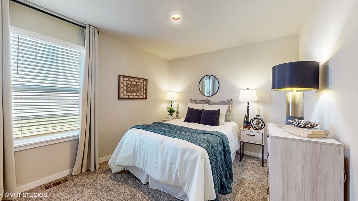 Comfortable secondary bedroom with natural light, modern finishes, and versatile living space.