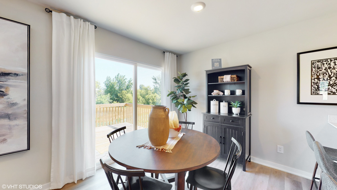 Open concept dining space with access to backyard