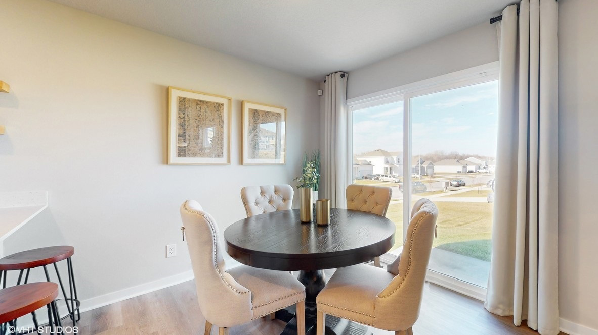 Open concept dining space with access to backyard