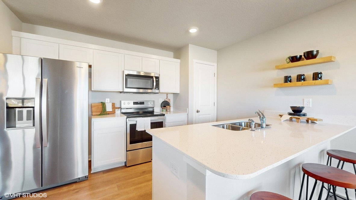 Kitchen with white cabinetry and quartz countertop
