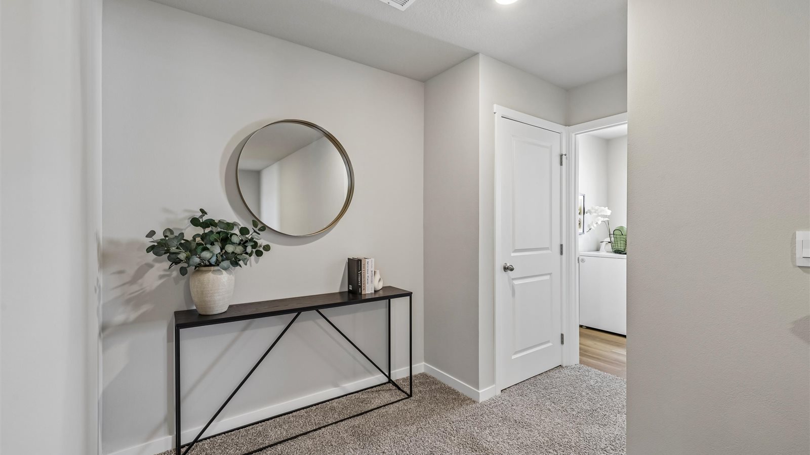 Open landing at the top of the stairs with room for a table and decorative accents.