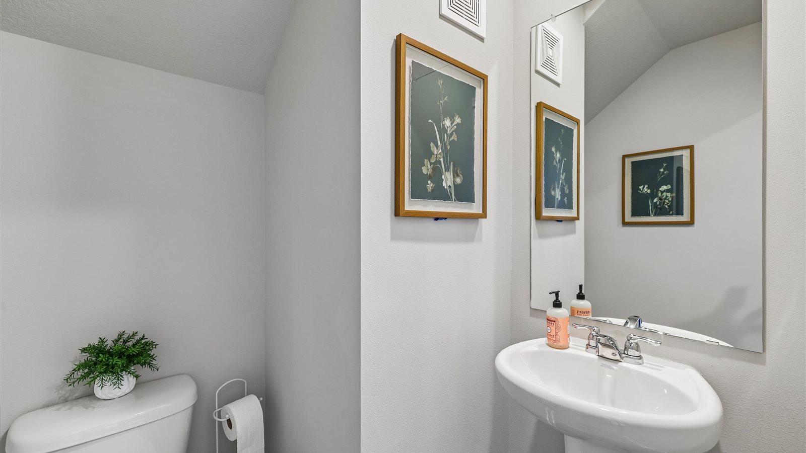 Convenient main-level powder room with updated fixtures and bright lighting.