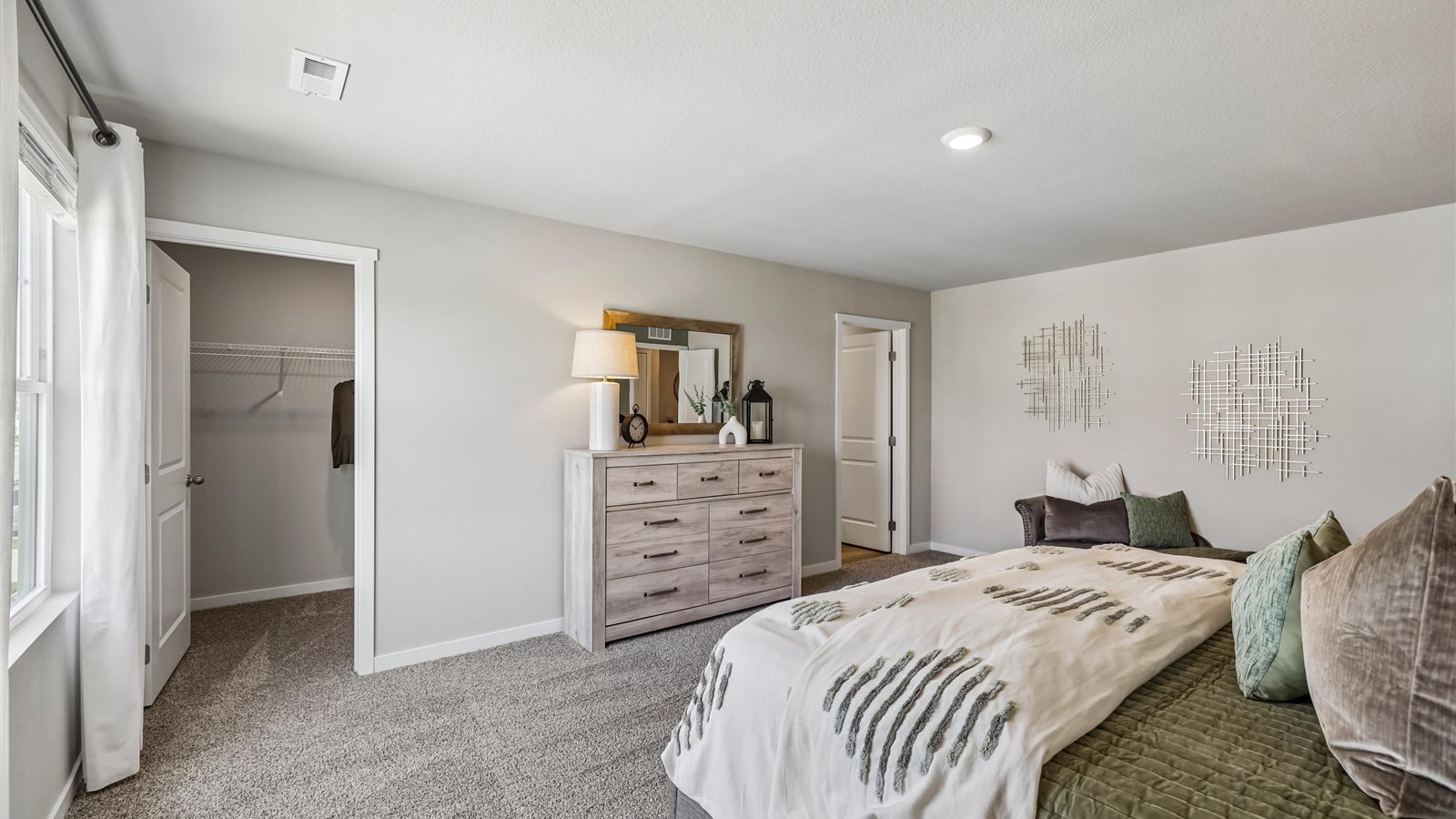 Primary bedroom with natural lighting and spacious layout