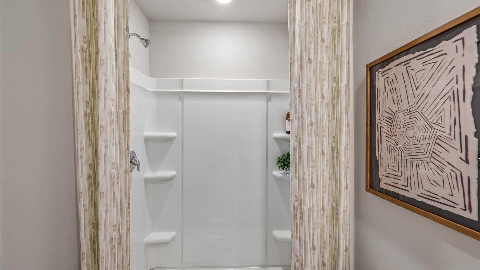 Spacious primary bathroom featuring dual vanities, modern fixtures, and a walk-in shower.