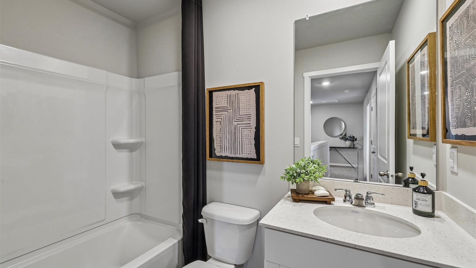 Stylish full bathroom with bright lighting and functional design.