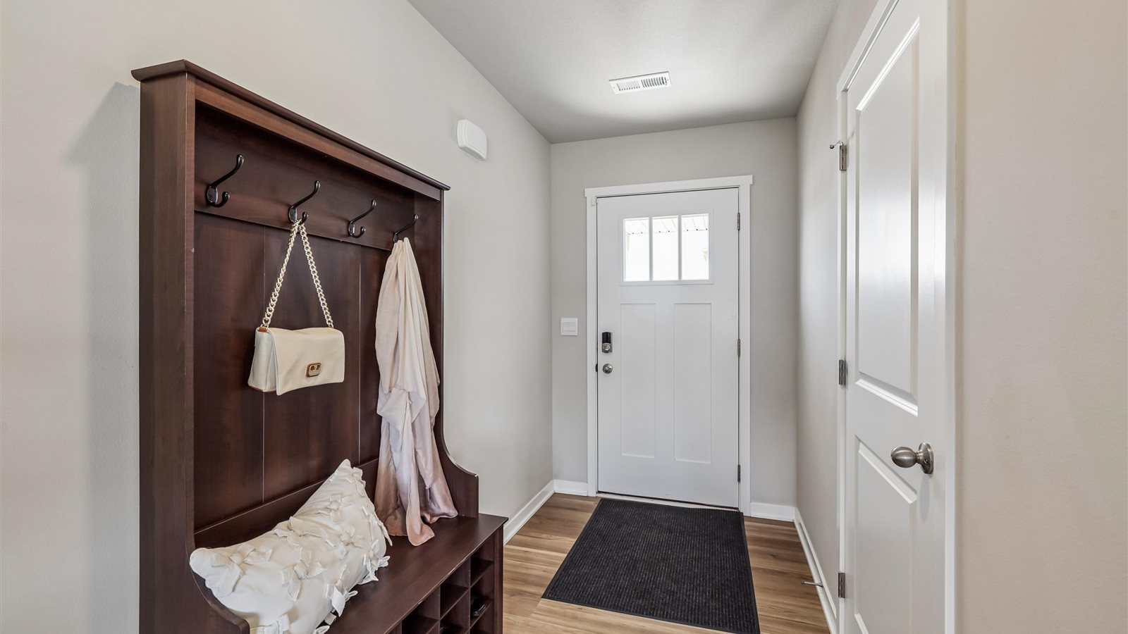 Welcoming townhouse entry hall with a half bathroom tucked just off the main walkway.