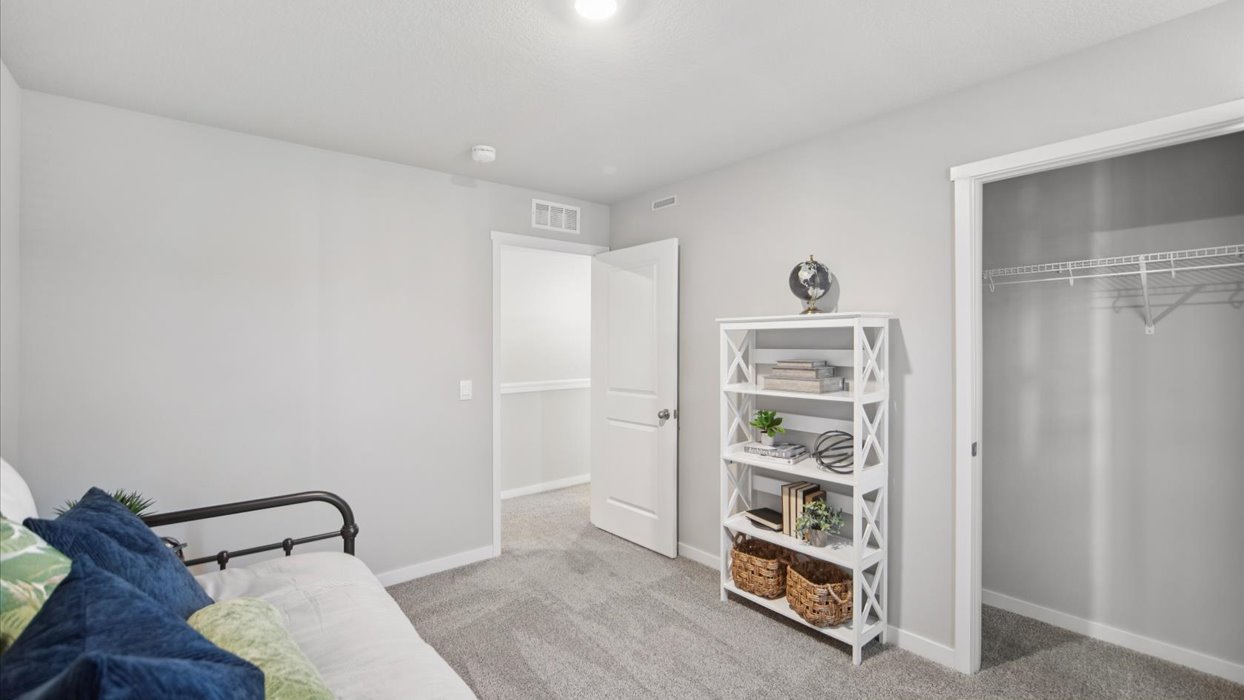 Comfortable secondary bedroom with natural light, modern finishes, and versatile living space.
