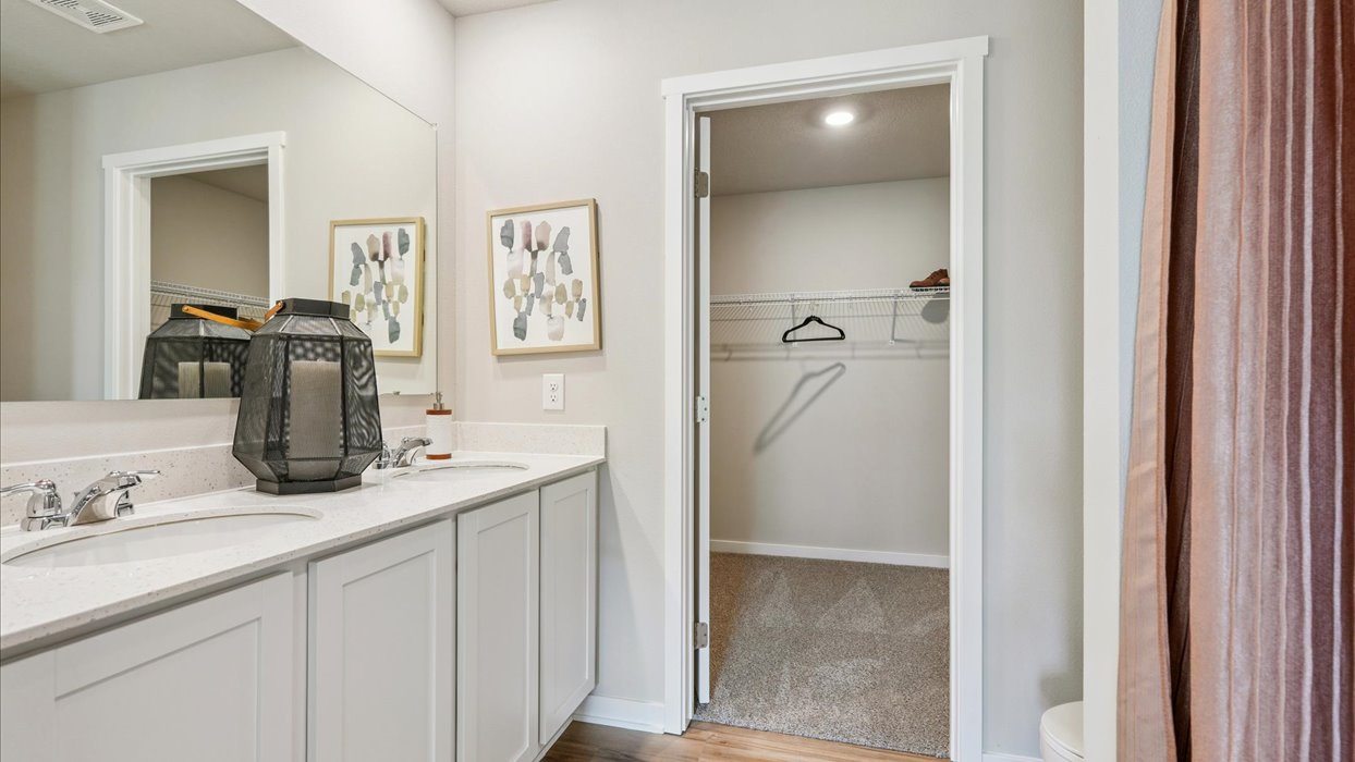 Spacious bathroom with white cabinetry and double sinks