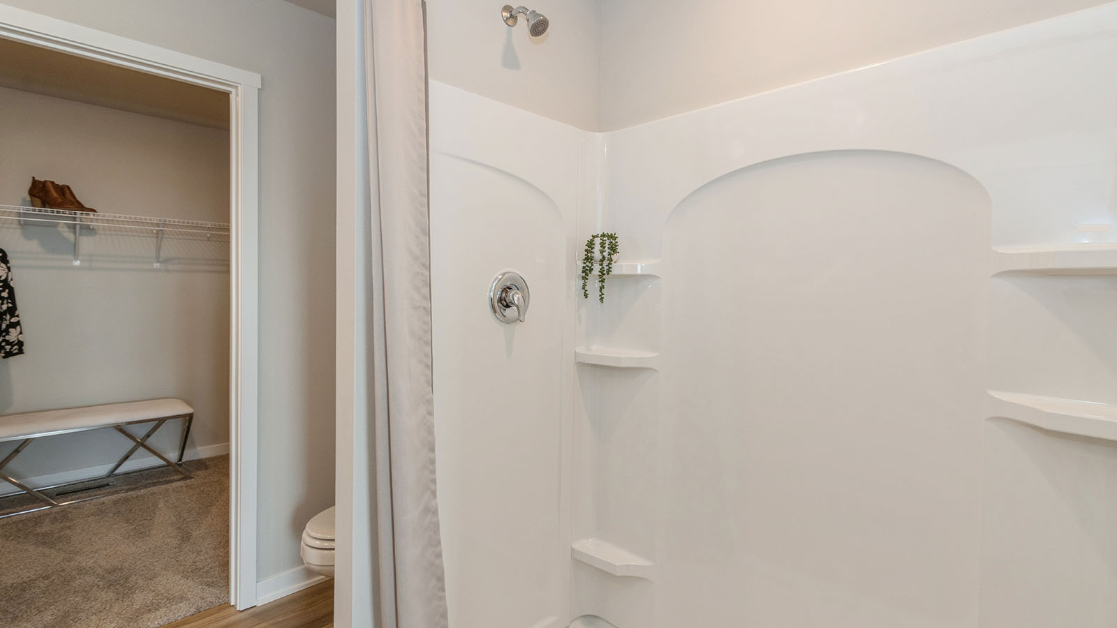 Spacious primary bathroom featuring dual vanities, modern fixtures, and a walk-in shower.