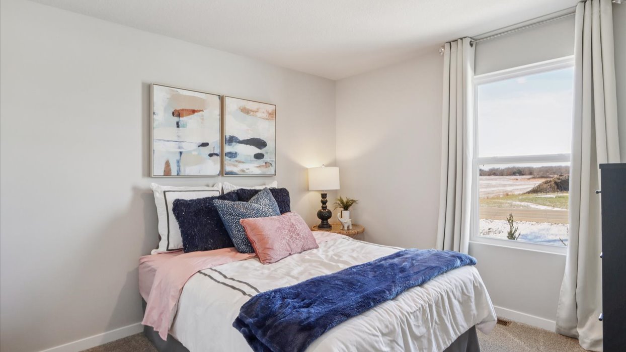 Comfortable secondary bedroom with natural light, modern finishes, and versatile living space.
