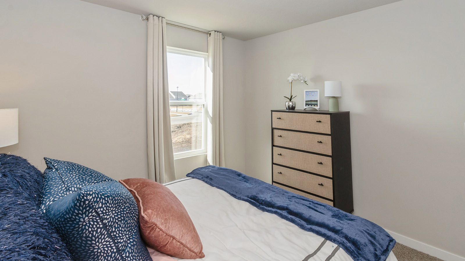 Comfortable secondary bedroom with natural light, modern finishes, and versatile living space.