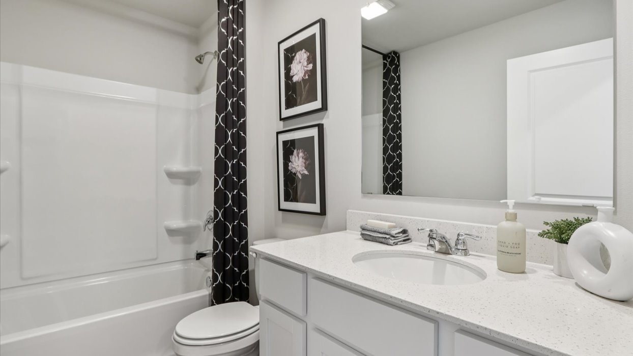 Stylish full bathroom with bright lighting and functional design.