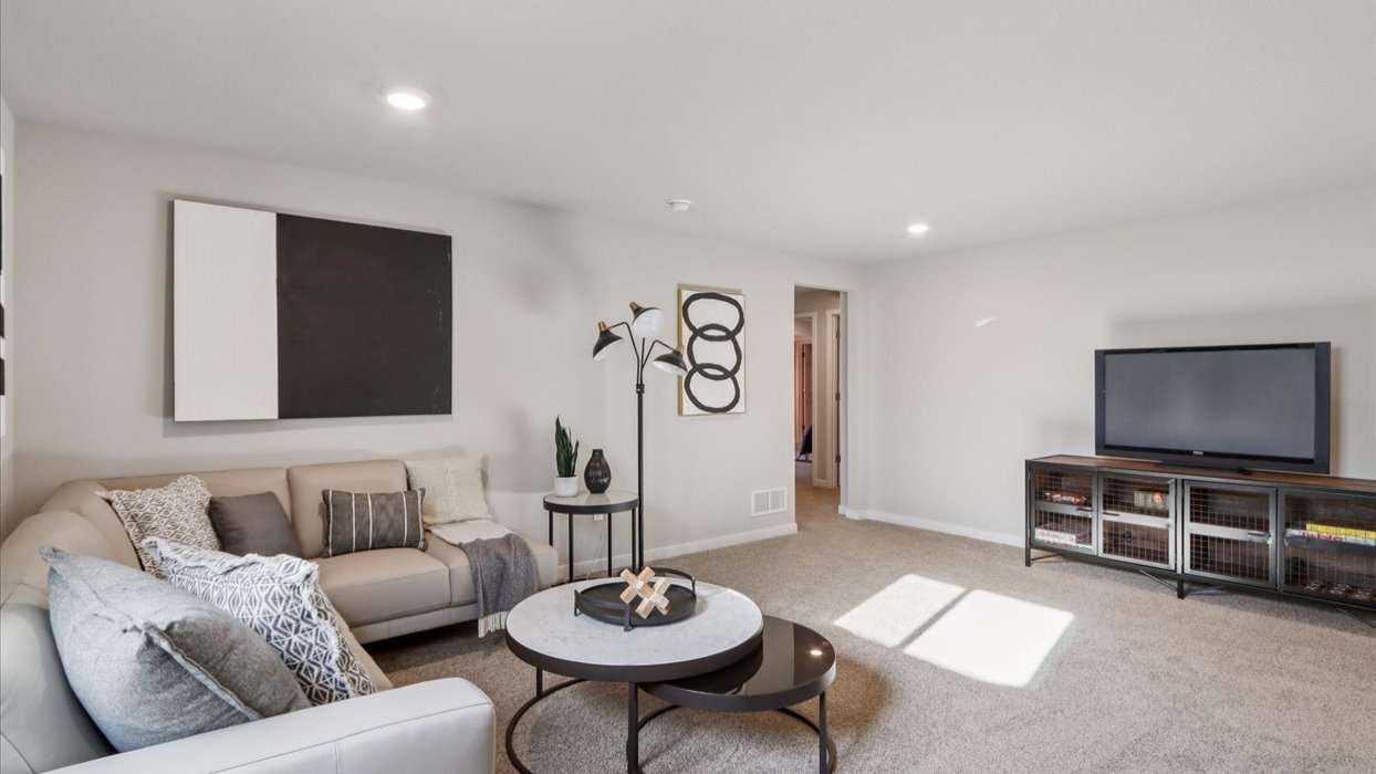 Finished basement living area with comfortable seating space and flexible room for entertaining or relaxing.