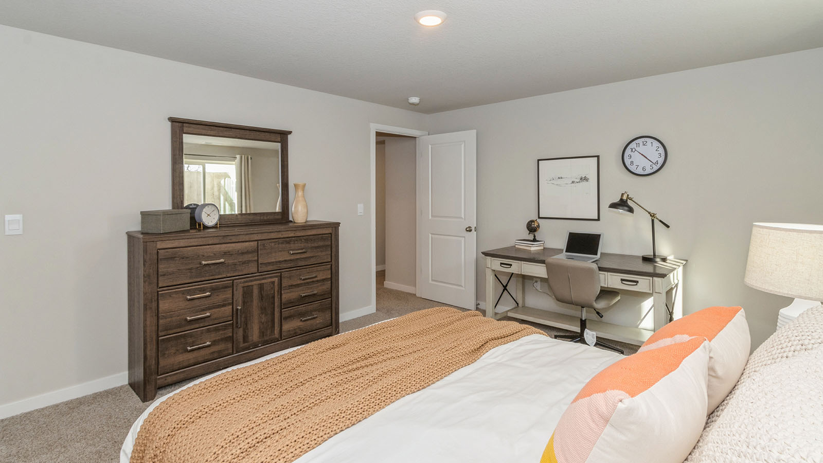 Private lower-level bedroom with natural light and functional storage space.