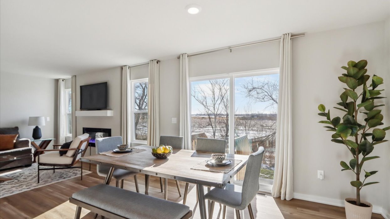 Open concept dining space with access to backyard