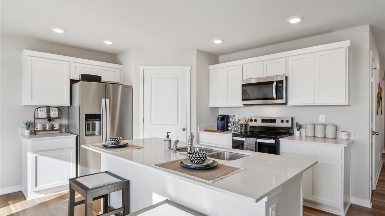 Kitchen with white cabinetry and quartz countertop