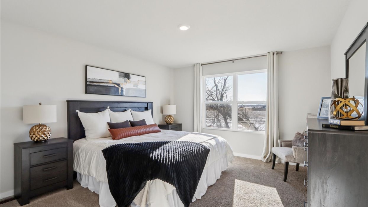 Primary bedroom with natural lighting and spacious layout