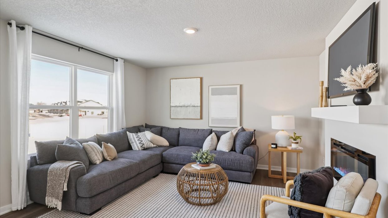 cozy living room with large window and grey couch