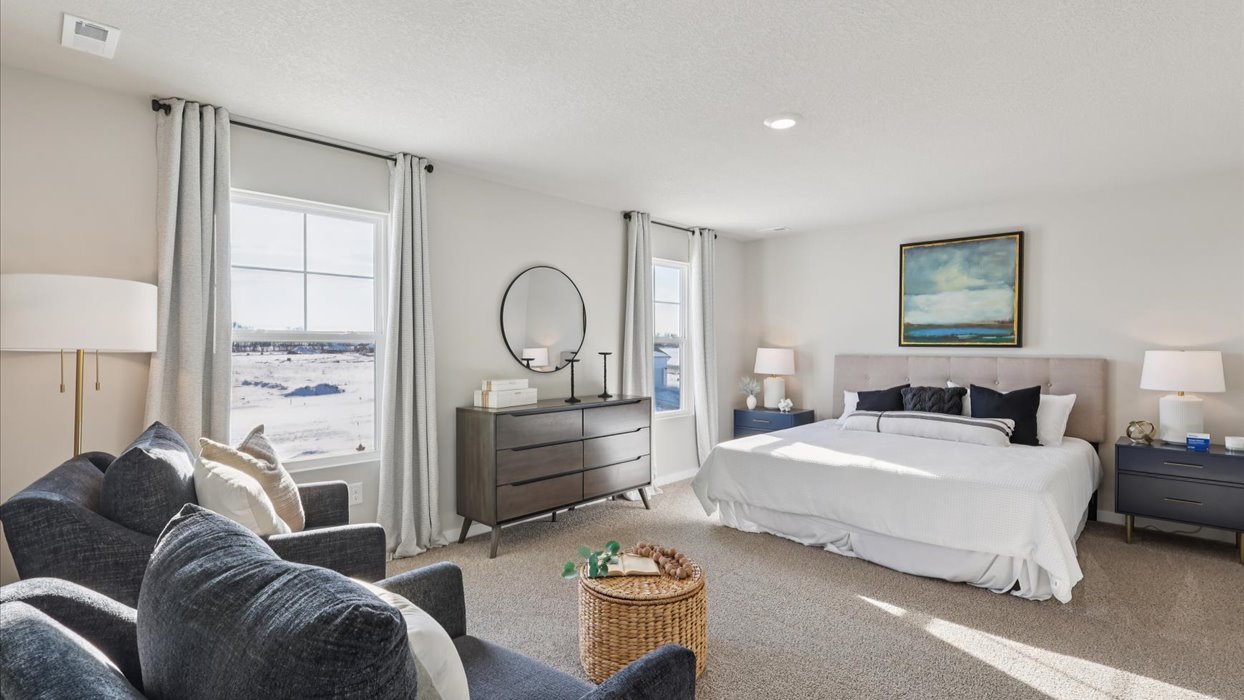 large primary bedroom with white bed and small windows