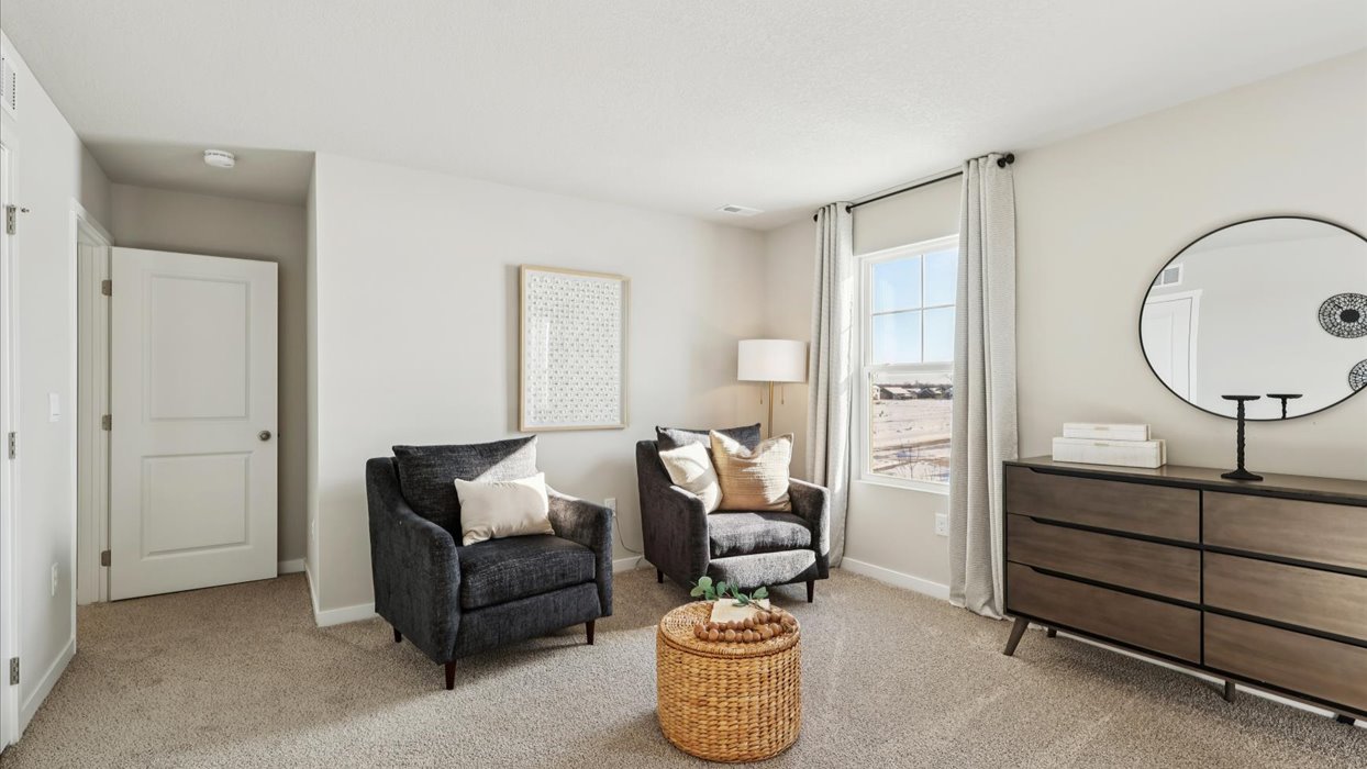 two black chairs in primary bedroom