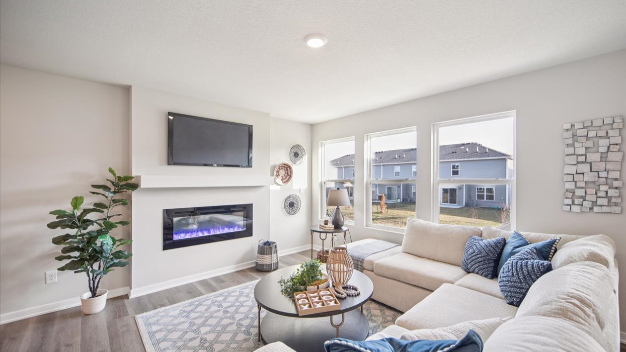 bright emerson living room with mounted tv and electric fireplace