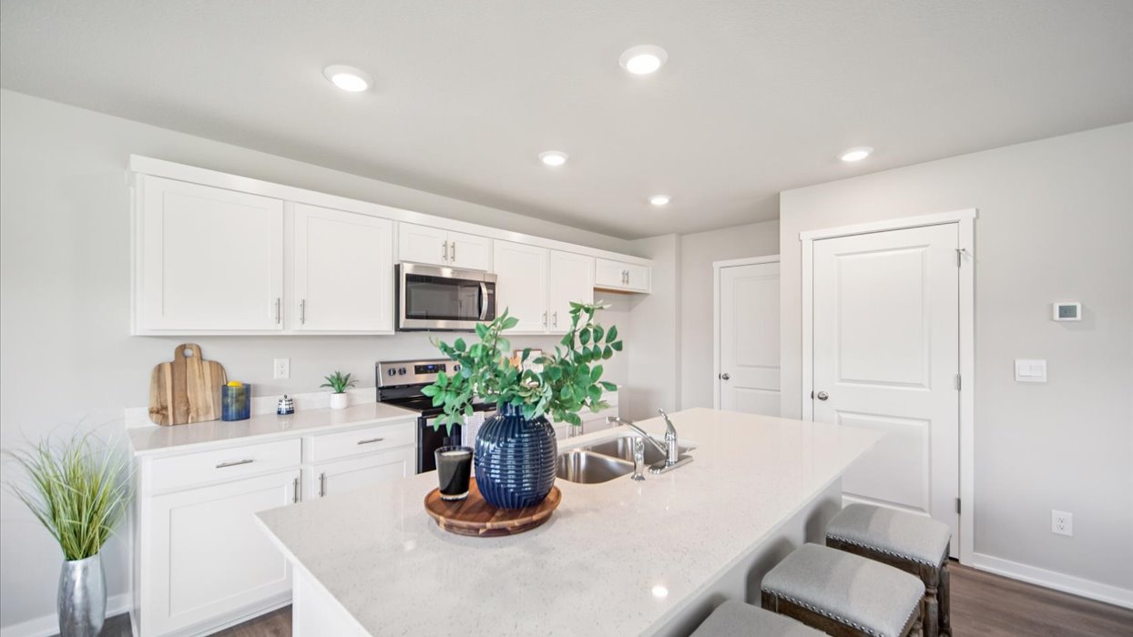 Kitchen with white cabinetry and quartz countertop